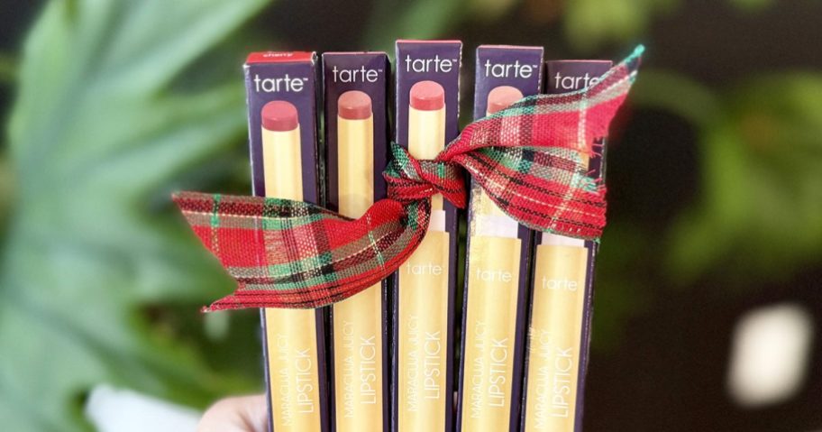 hand holding 5 <a href='https://sjf.a8c.myftpupload.com/product/wild-elegance-collection' target='_blank' rel='follow'>boxes</a> of Tarte Maracuja Juicy Lipsticks with Christmas bow” width=”912″ height=”479″></p>
<p>Through December 24th or while supplies last, head over to <a href=