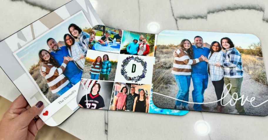 3 different styles of photo mousepads on a counter, person holding 1 of them