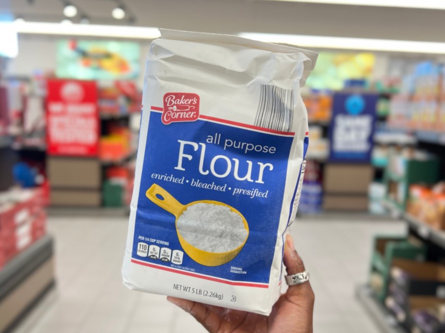 holding a bag of flour