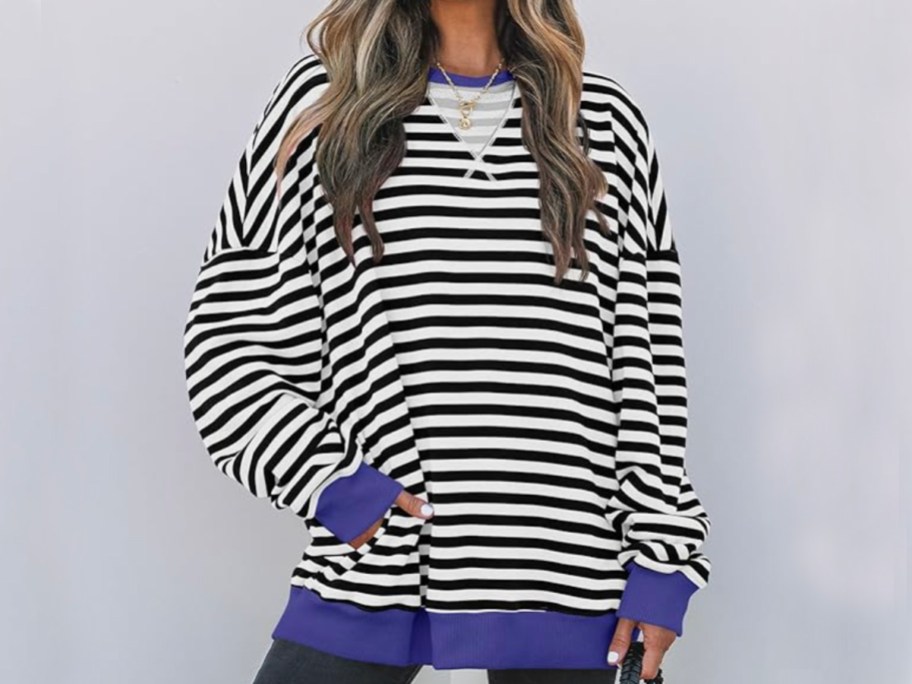 woman wearing white and black striped sweatshirt 