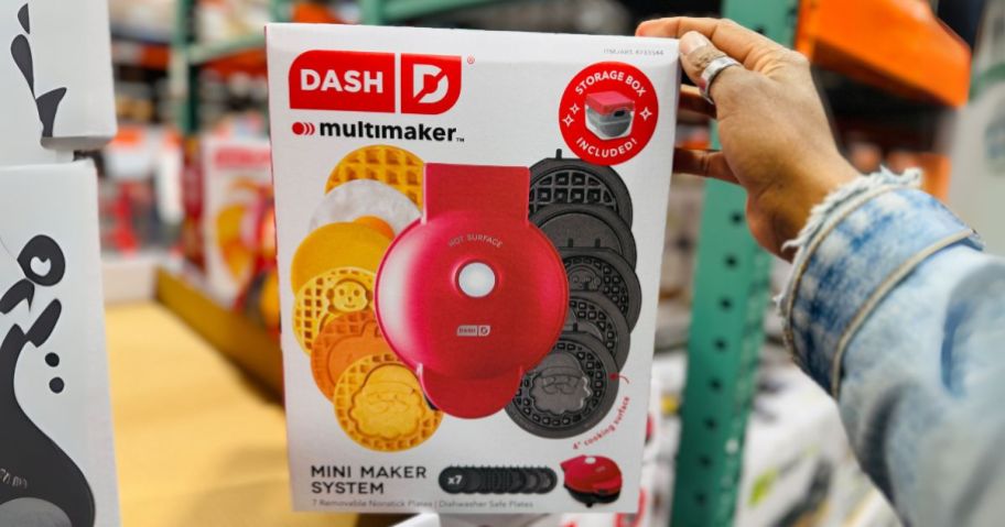 hand holding Dash MultiMaker Mini Waffle System with Removable Plates & Storage Case in store