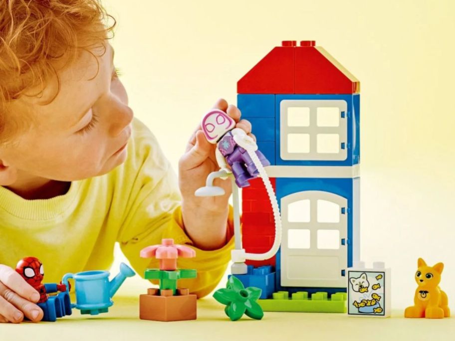 Little boy playing with LEGO DUPLO Marvel Spider-Man’s House