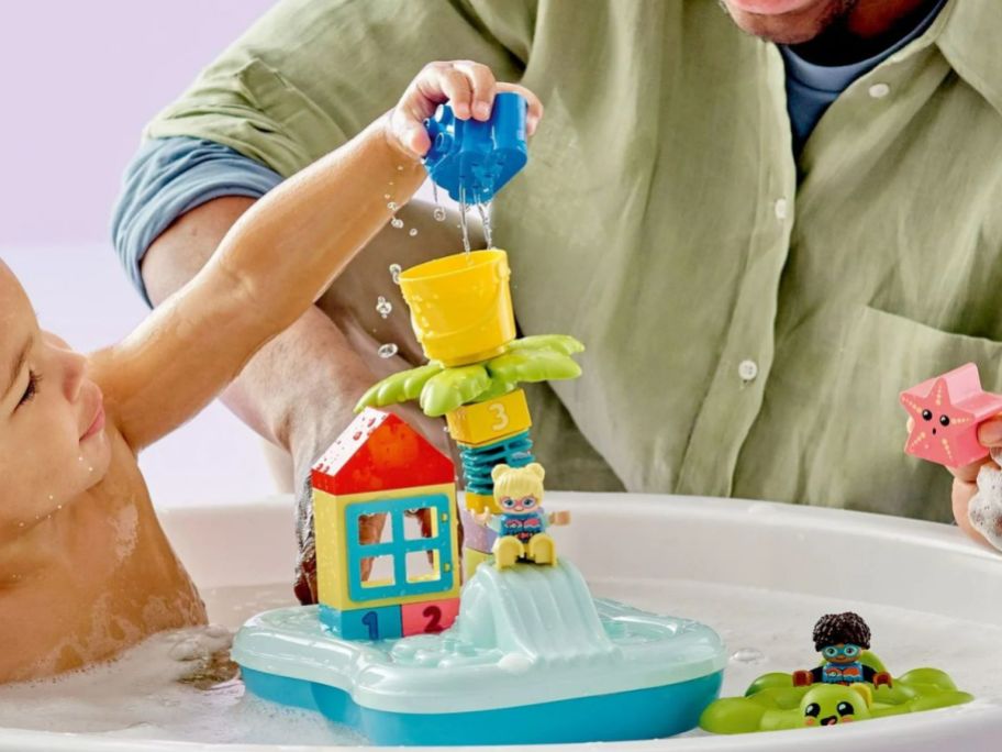 Little boy in a tub playing with a LEGO DUPLO Town Water Park