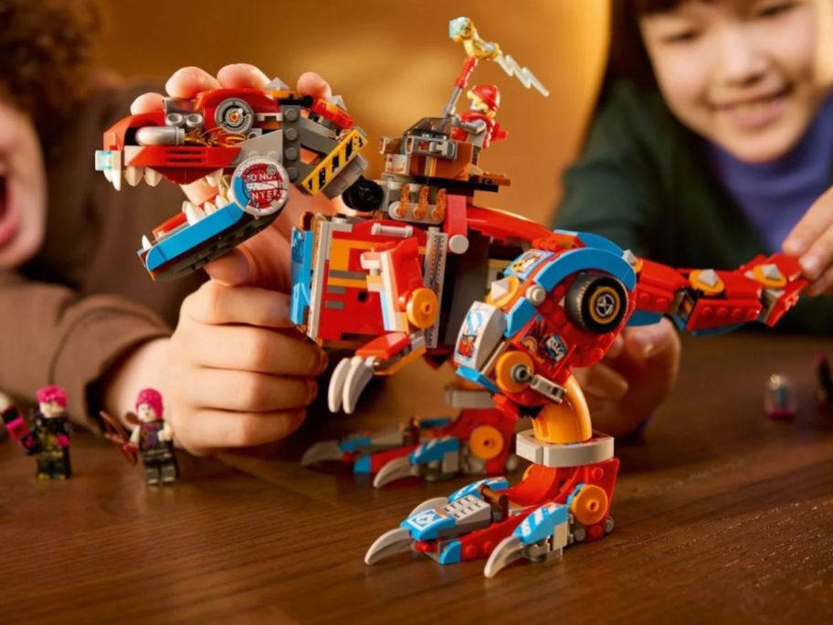 A Boy and girl playing with.a LEGO DREAMZzz Cooper’s Robot Dinosaur C-Rex