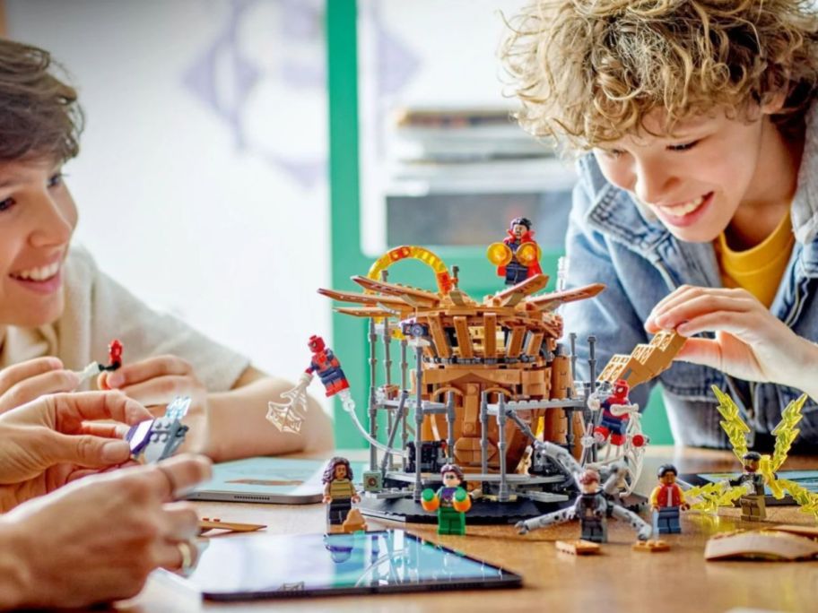 teen boys playing with a LEGO Marvel Spider-Man Final Battle Building Toy Set