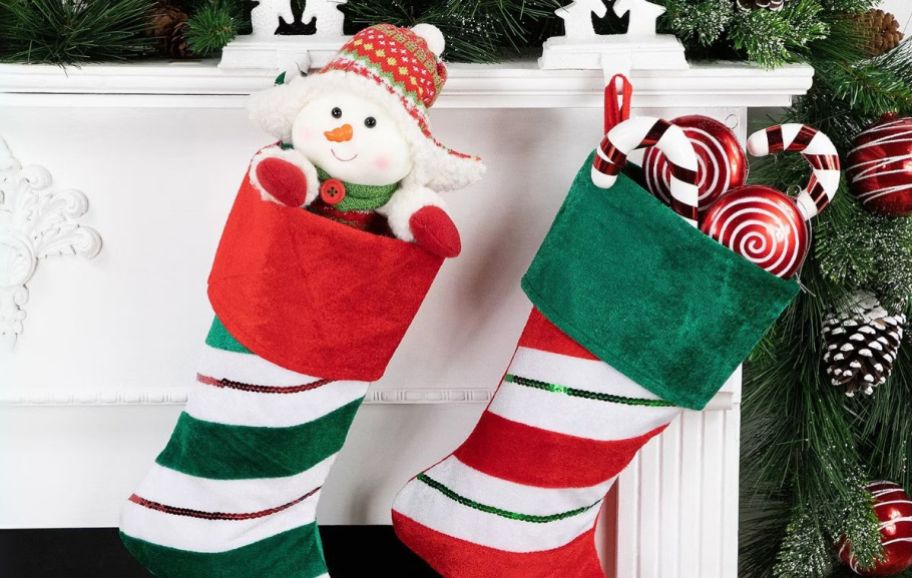 two christmas stockings hanging on a mantle