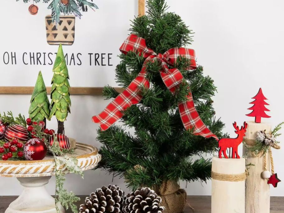 small Christmas tree on counter with other Christmas decor