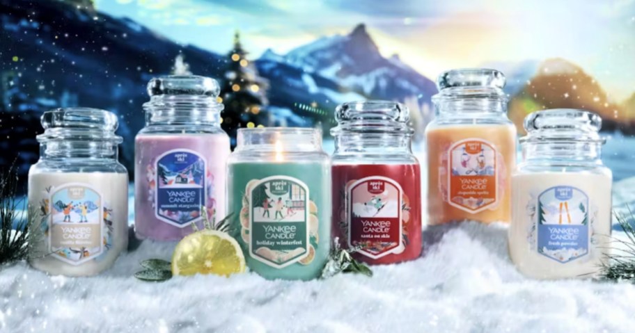 holiday themed Yankee Candles in front of snow scene