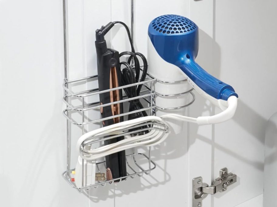 metal hair dryer organizer hanging on white cabinet door small bathroom storage ideas