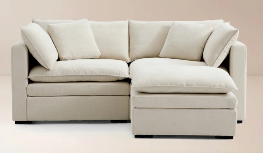 beige loveseat and ottoman