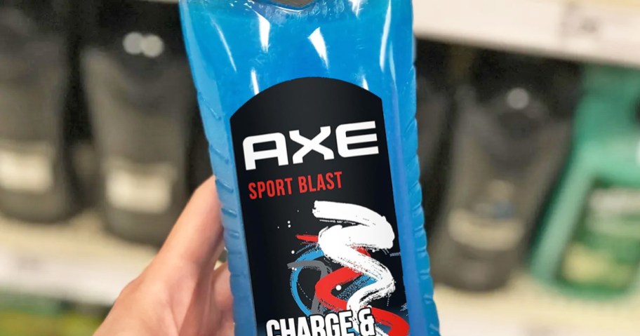 hand holding a blue bottle of Axe Charge & Hydrate Sport Blast Body Wash in store