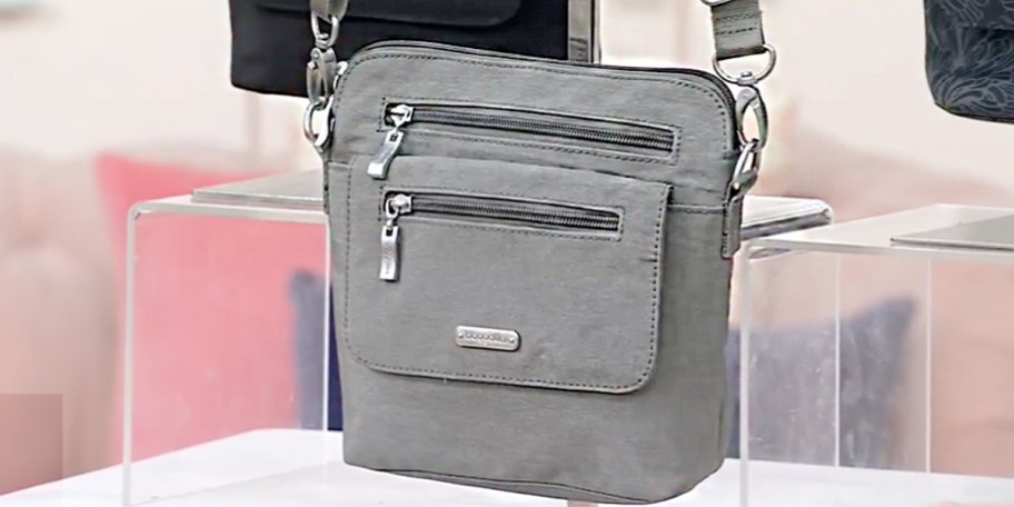 gray crossbody bag hanging 