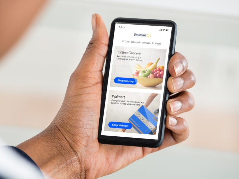 holding phone with open Walmart app