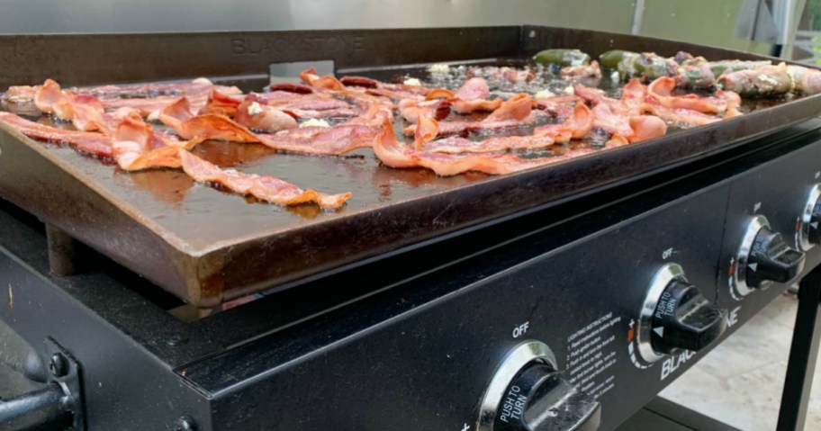 blackstone griddle with bacon cooking on <a href='https://www.dealfordeals.in/artificial-grass' target='_blank' rel='follow'>top</a> ” width=”912″ height=”479″></p>
<div class=