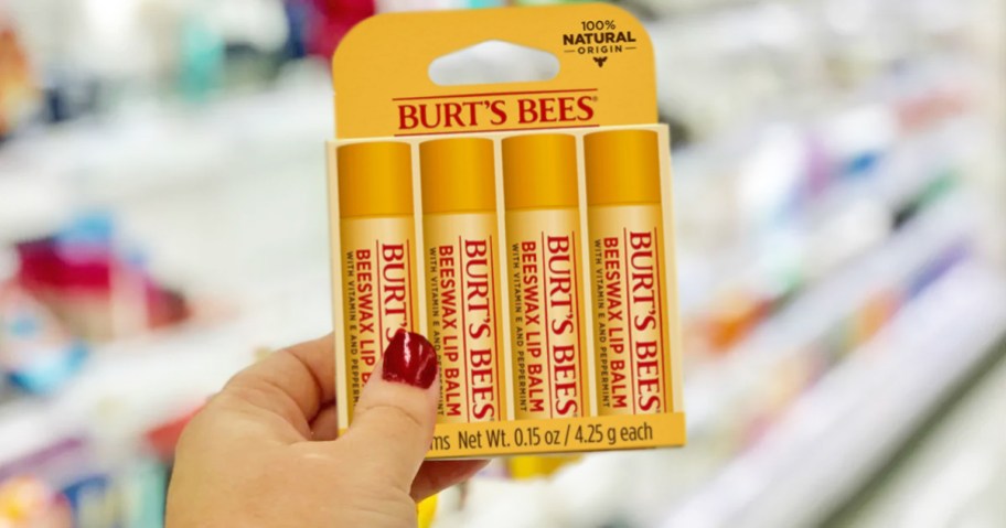 hand holding up Burt's Bees Beeswax Lip Balm 4-Pack in store