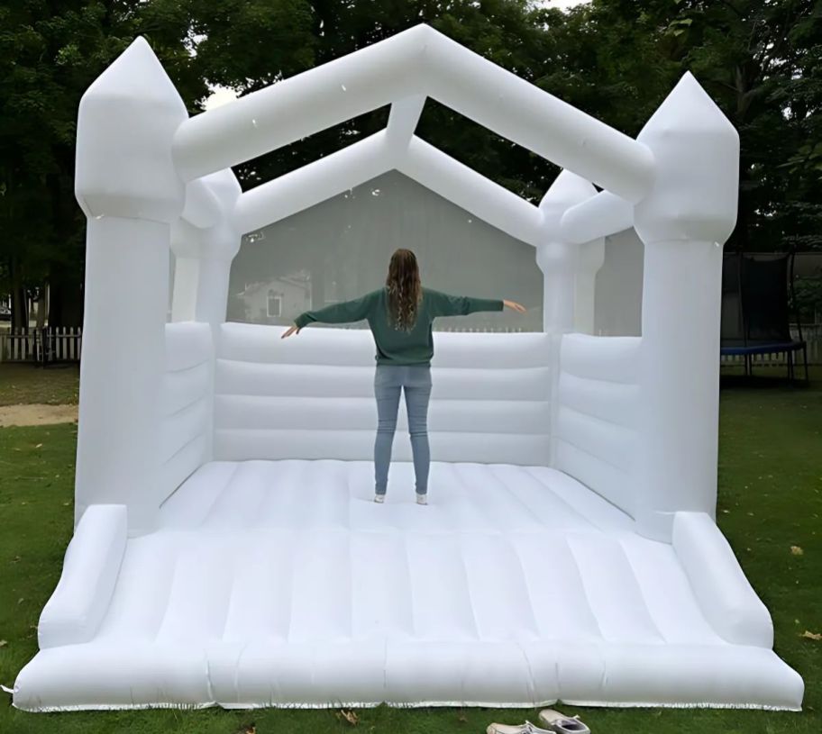 a woman standing inside an inflated bounce house