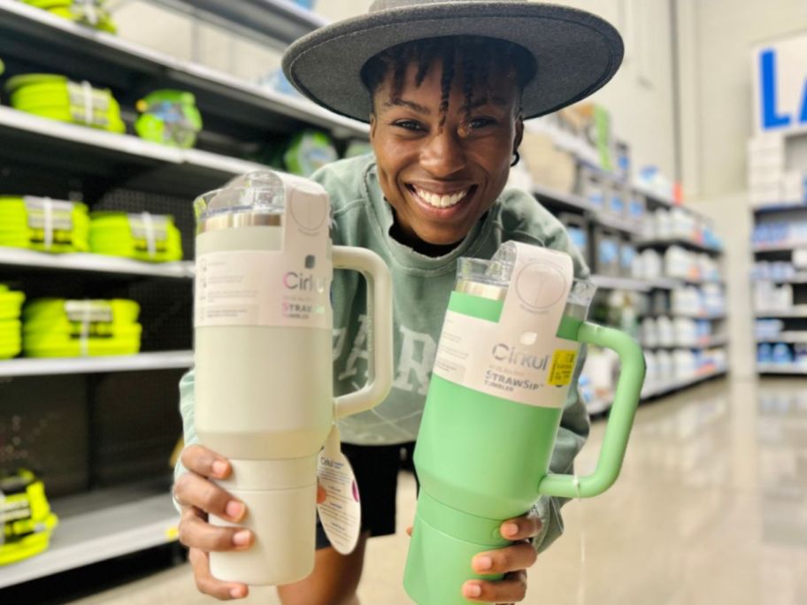 Woman holding two Cirkul tumblers