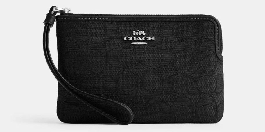 a black signature fabric coach wristlet stock image