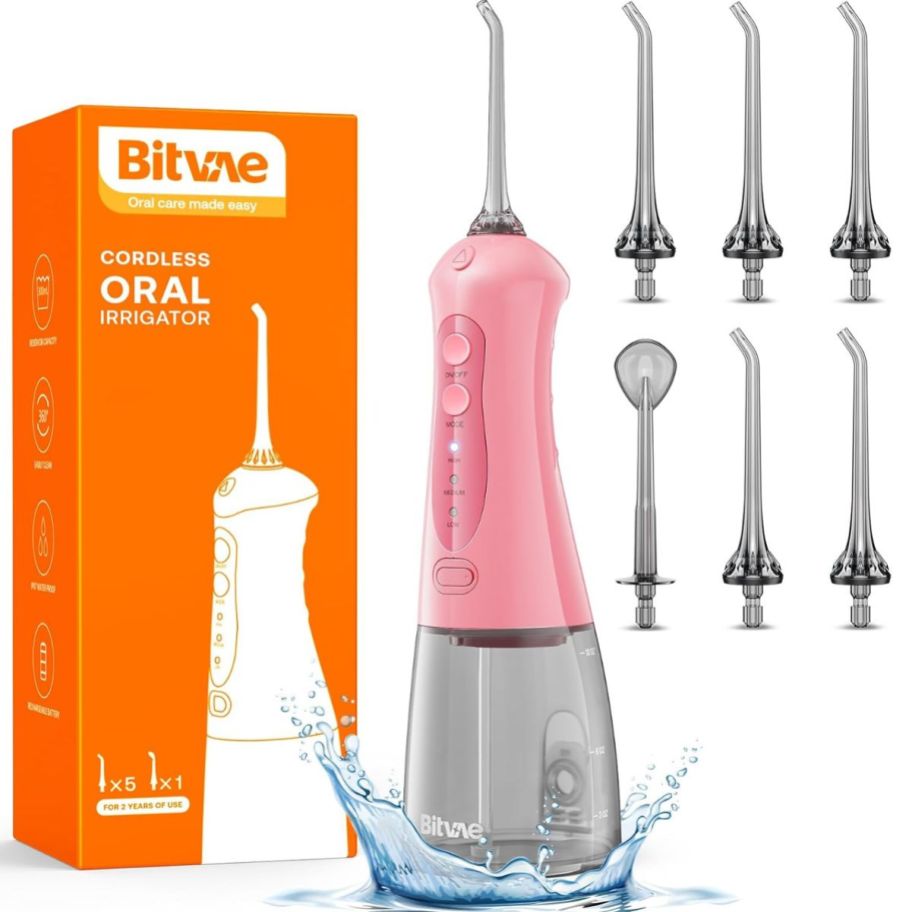 pink bitvae water flosser with attachments stock image