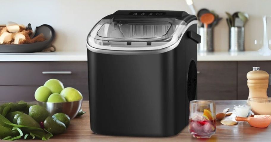 Antarctic Star Countertop Ice Maker Machine w/ Handle in Black on counter with food around it