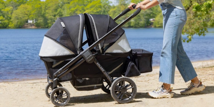 woman pushing black and gray stroller wagon 