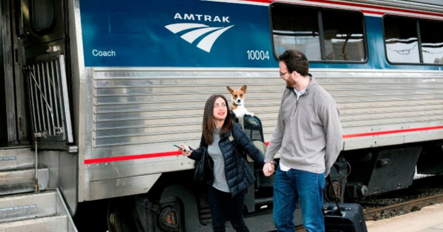 Man and woman walking to entrance of passenger train