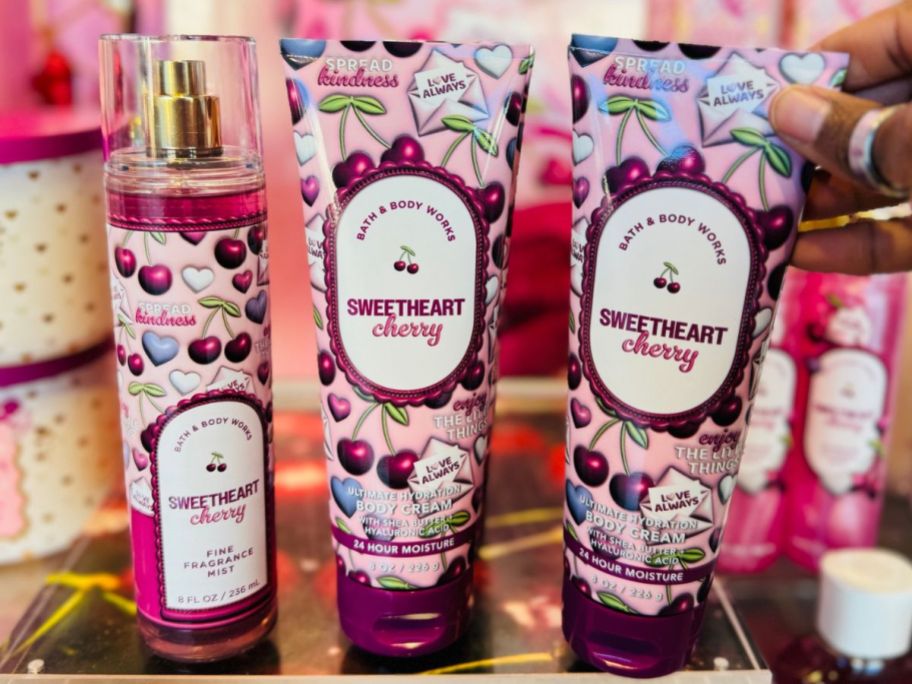 A Bottle of Bath & Body Works Sweetheart Cherry Fine Fragrance Mist and two body creams