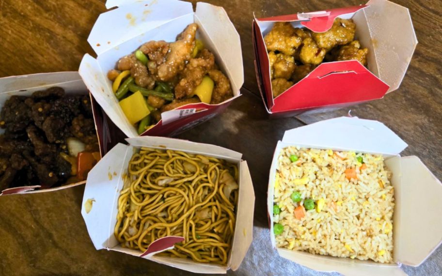 five panda express food containers on a tabletop