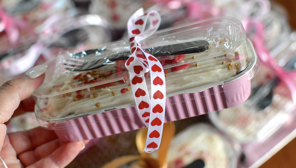 holding mini Valentine cakes 