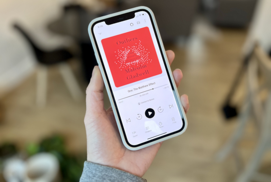 hand holding a phone with audible book on screen