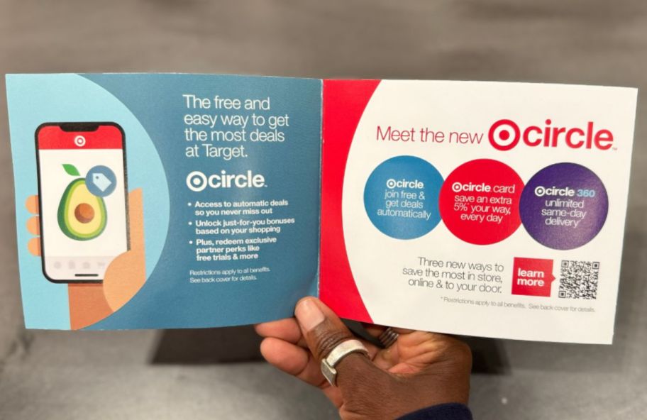 a womans hand holding a target circle membership brochure