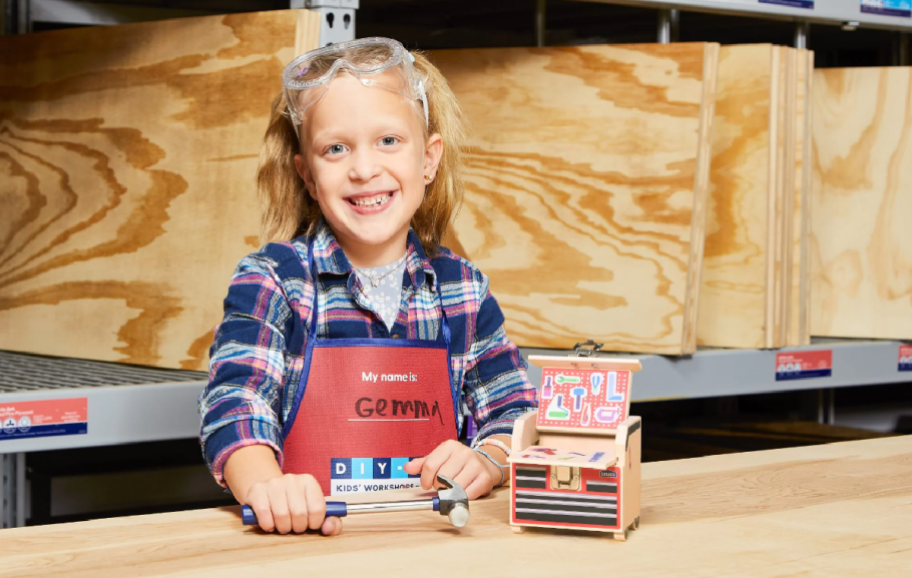 Lowe's Free kids Workshops where a girl is making a toy chest