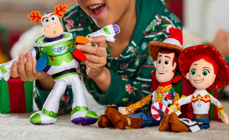 boy playing with Disney Toy Story Holiday Plush Set