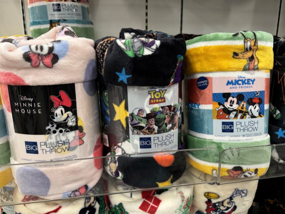 three disney blankets on shelf 