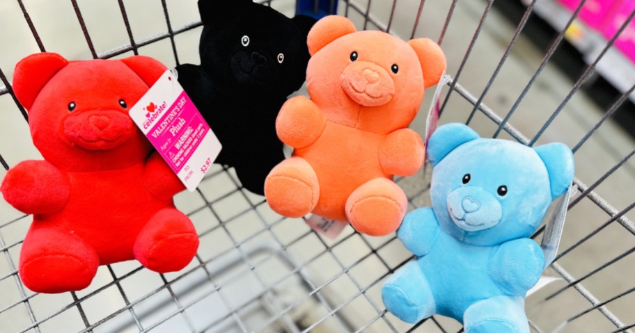 red, orange, blue, and black gummy bear plushies in shopping cart