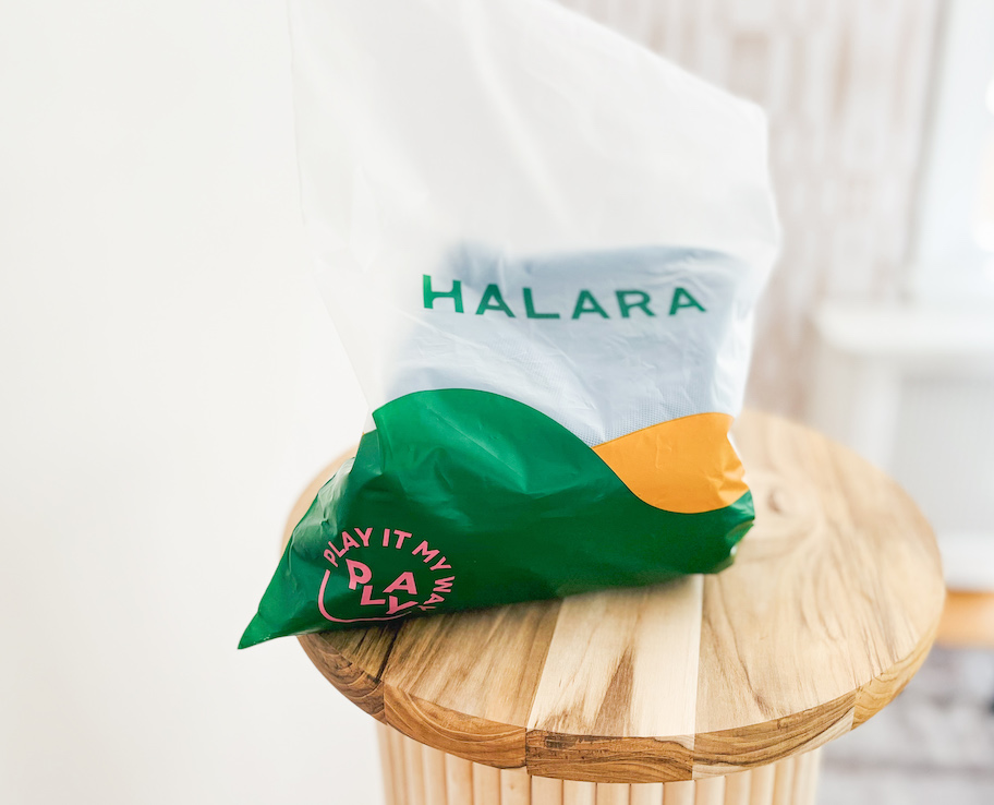 halara plastic bag sitting on fluted wood table