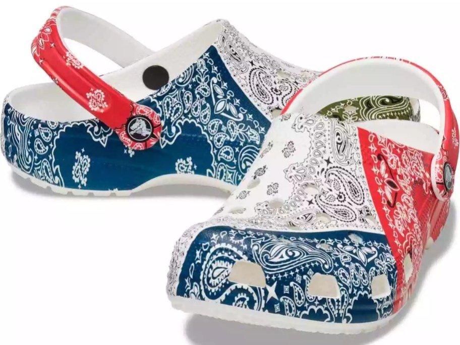 a pair of Crocs clog shoes with a red, white blue, and green bandana print