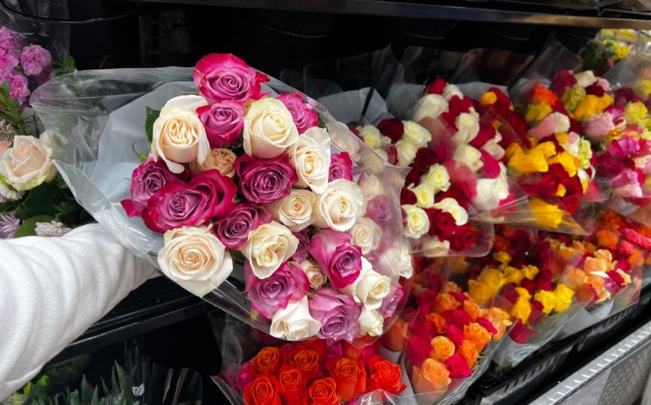 hand holding roses from the grocery store