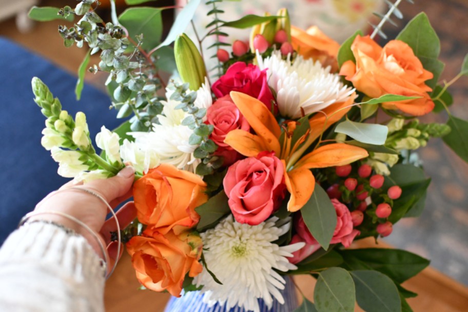 arranging flowers in a vase