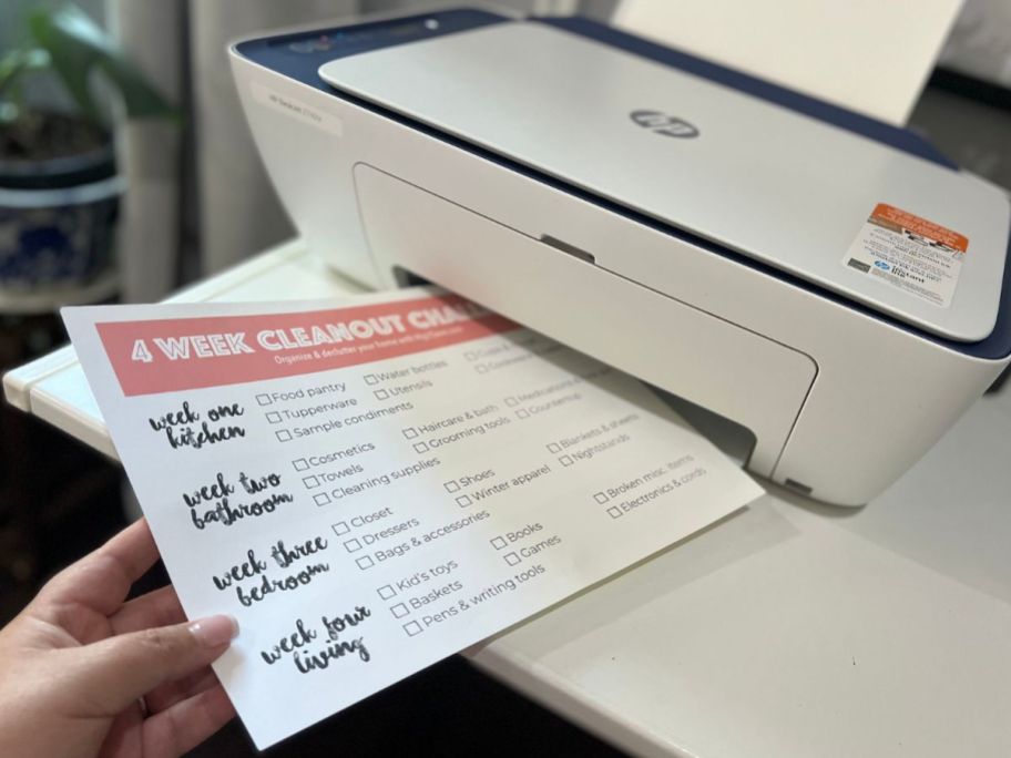 printer with the 4-week home declutter challenge checklist on it