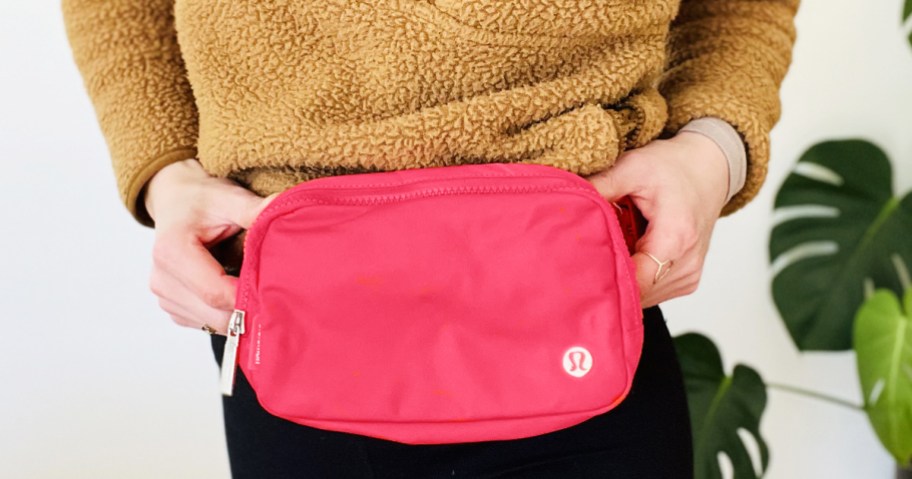 woman wearing a bright pink lululemon Everywhere Belt Bag