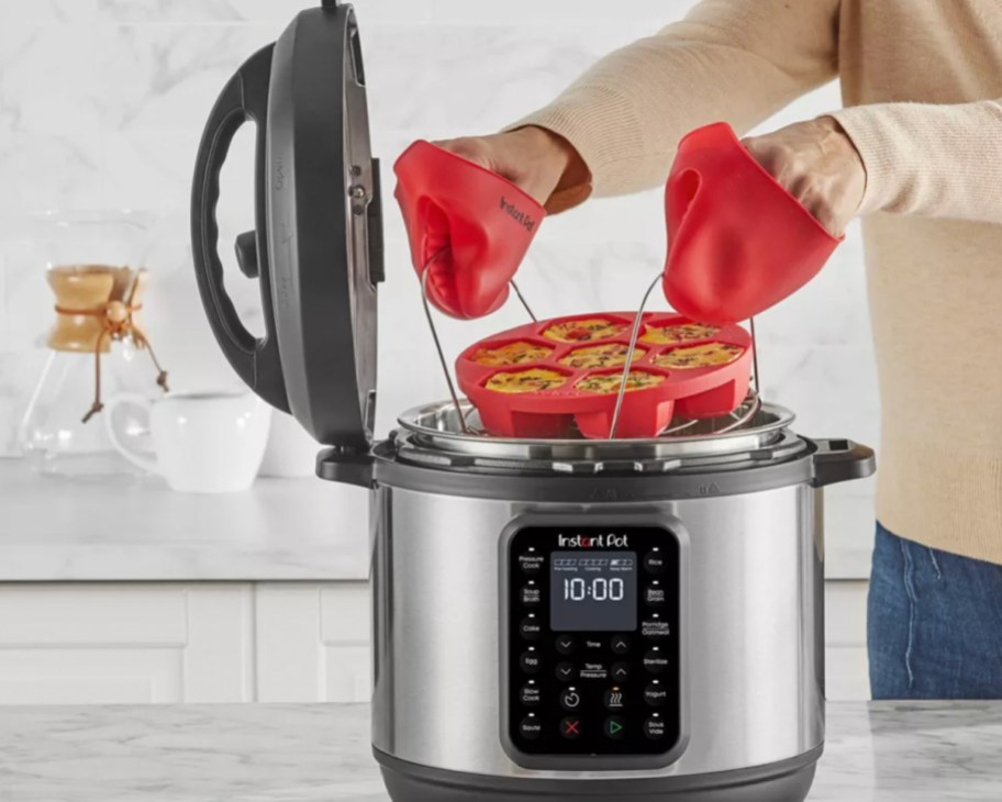 hands grabbing rack out of instant pot