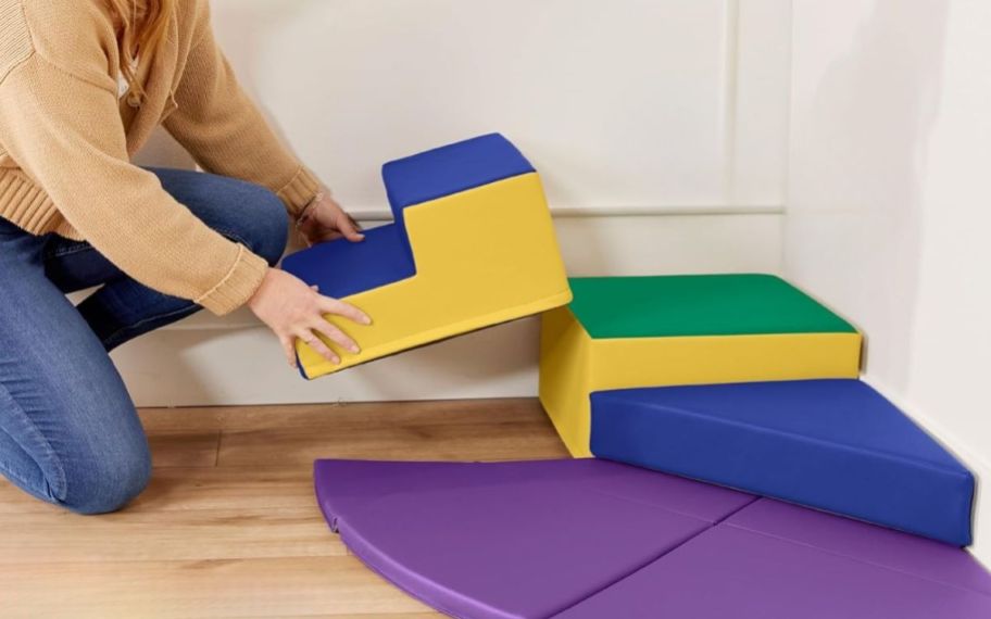 a woman adding the steps to the Summit Step corner climber