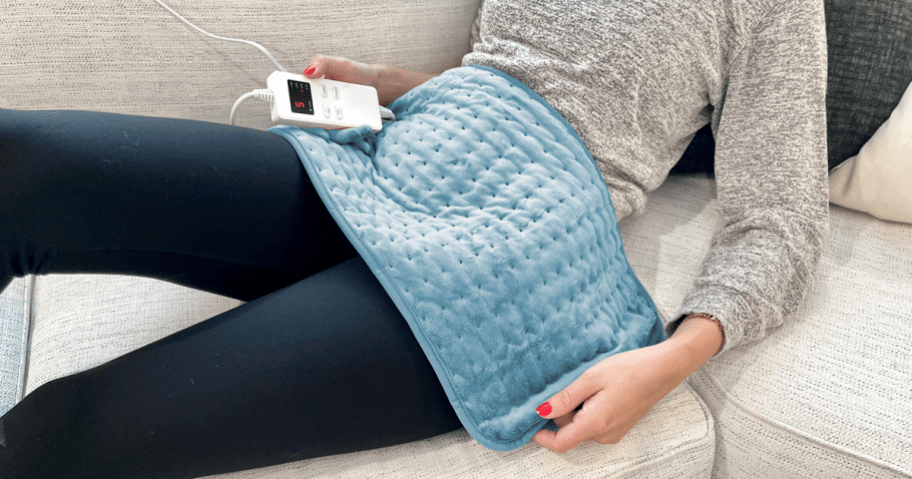 person sitting on the couch with zuodon heating pad