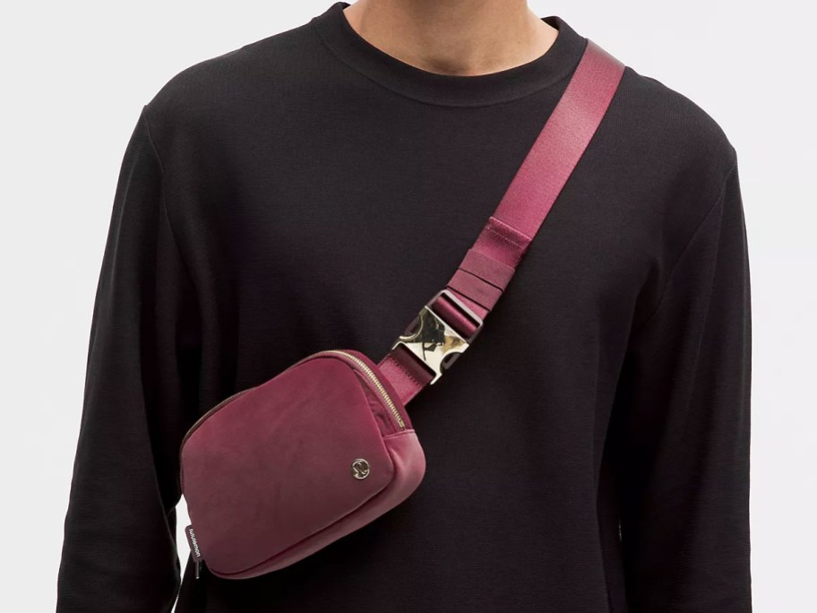 man wearing a maroon lululemon velour belt bag