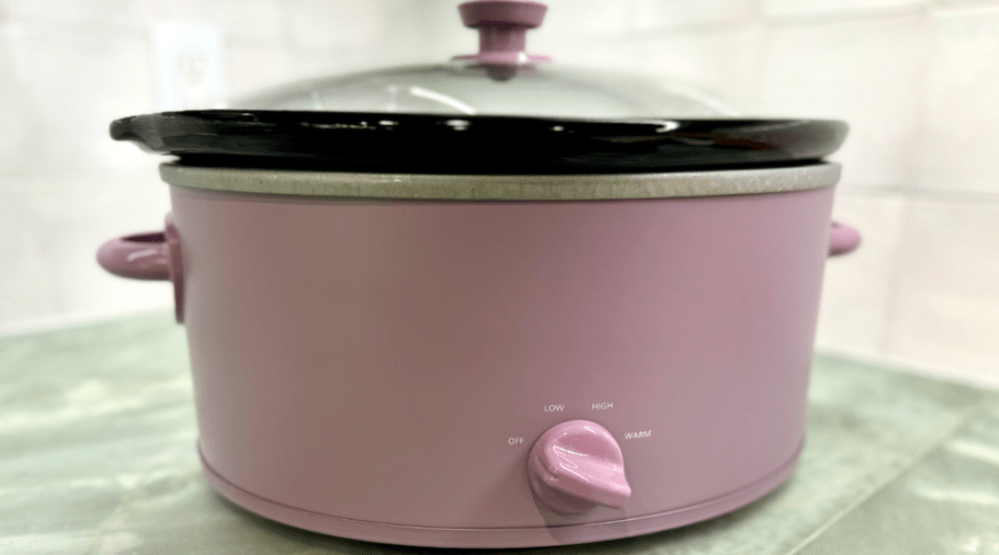 a light purple color large slow cooker on a grey counter