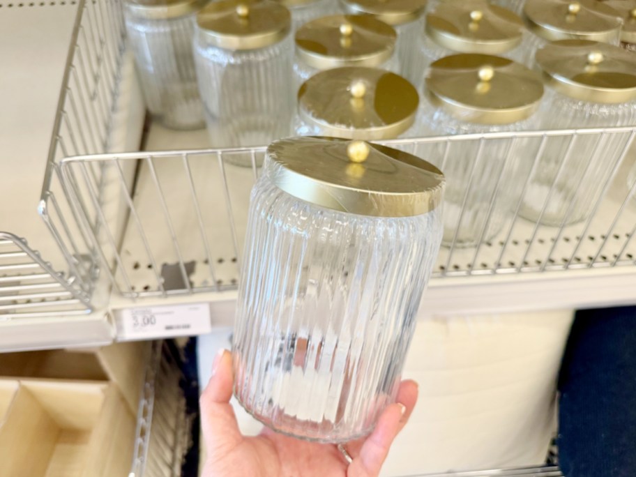 hand holding glass canister