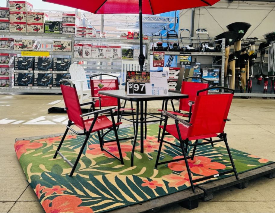 red metal 5 piece outdoor dining set in a garden center