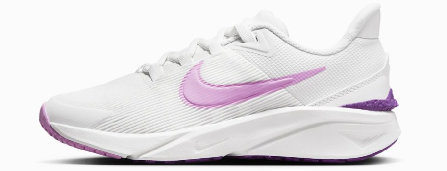 white and pink nike running shoe