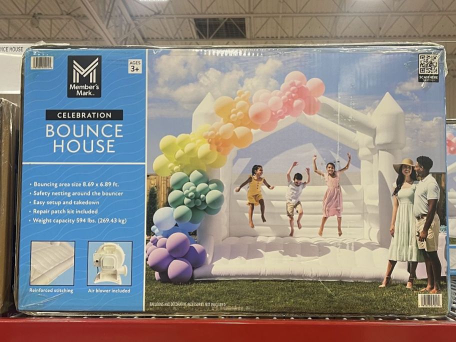 a white inflatable bounce house in a box on a store shelf